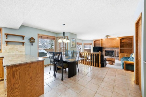 86 Suncanyon Park Se, Calgary, AB - Indoor Photo Showing Dining Room With Fireplace