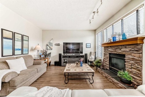 42 Somerset Circle Sw, Calgary, AB - Indoor Photo Showing Living Room With Fireplace