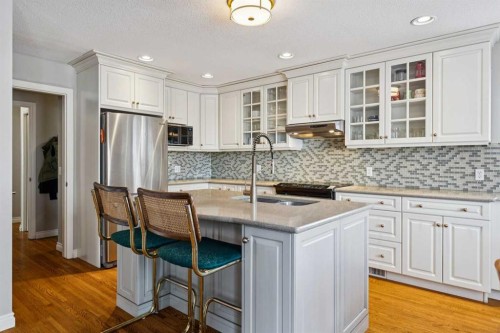 107 Sheep River Bay, Okotoks, AB - Indoor Photo Showing Kitchen With Stainless Steel Kitchen With Upgraded Kitchen