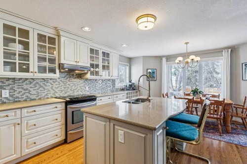 107 Sheep River Bay, Okotoks, AB - Indoor Photo Showing Kitchen With Double Sink
