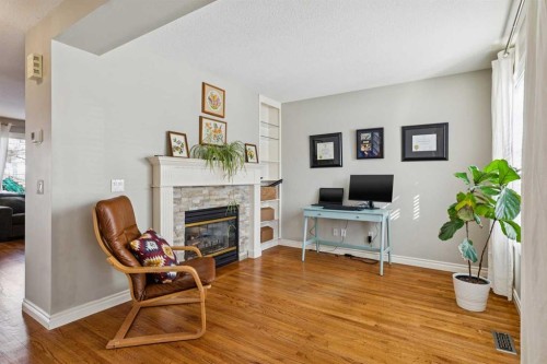 107 Sheep River Bay, Okotoks, AB - Indoor Photo Showing Living Room With Fireplace
