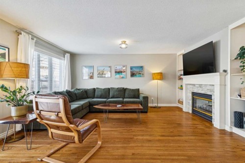107 Sheep River Bay, Okotoks, AB - Indoor Photo Showing Living Room With Fireplace