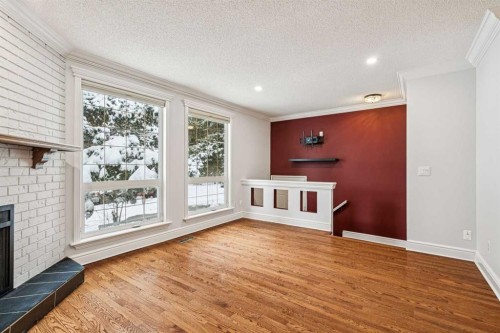 131 Woodglen Way Sw, Calgary, AB - Indoor With Fireplace
