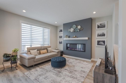 301 Crestmont Drive Sw, Calgary, AB - Indoor Photo Showing Living Room With Fireplace