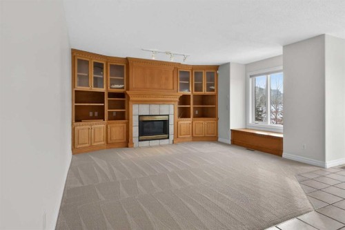 255 Hamptons Terrace Nw, Calgary, AB - Indoor Photo Showing Other Room With Fireplace