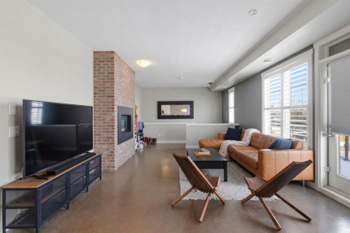 237 Mckenzie Towne Link Se, Calgary, AB - Indoor Photo Showing Living Room With Fireplace