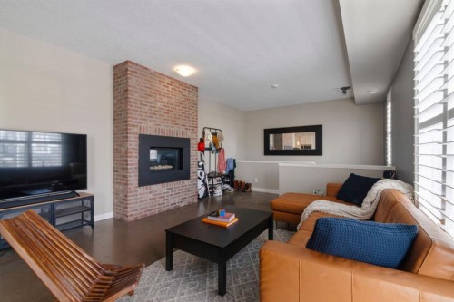 237 Mckenzie Towne Link Se, Calgary, AB - Indoor Photo Showing Living Room With Fireplace