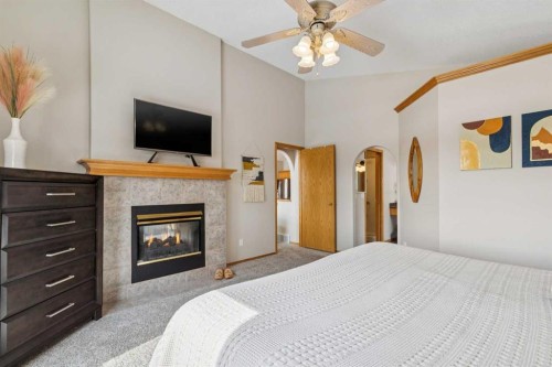 113 Westchester Way, Chestermere, AB - Indoor Photo Showing Bedroom With Fireplace