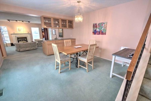 6719 Coach Hill Road Sw, Calgary, AB - Indoor Photo Showing Dining Room With Fireplace