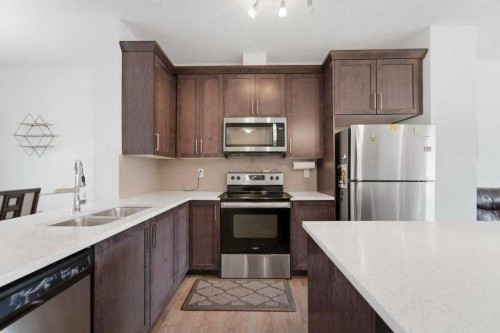148 Legacy Point Se, Calgary, AB - Indoor Photo Showing Kitchen With Stainless Steel Kitchen With Double Sink With Upgraded Kitchen