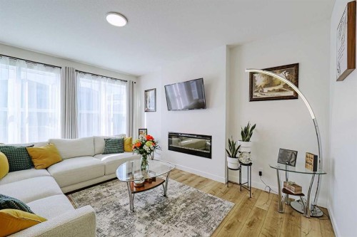 25 Belmont Green Sw, Calgary, AB - Indoor Photo Showing Living Room With Fireplace