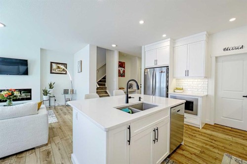25 Belmont Green Sw, Calgary, AB - Indoor Photo Showing Kitchen With Double Sink With Upgraded Kitchen