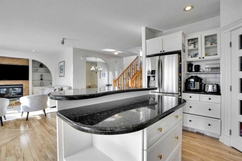 6 Strathridge Way Sw, Calgary, AB - Indoor Photo Showing Kitchen With Fireplace