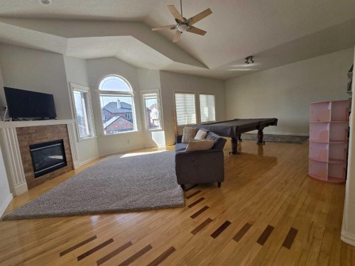 6 Strathridge Way Sw, Calgary, AB - Indoor Photo Showing Other Room With Fireplace