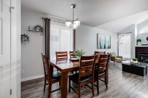 138 Prestwick Circle Se, Calgary, AB - Indoor Photo Showing Dining Room With Fireplace