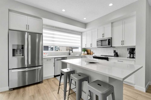 125 Emberside Hollow, Cochrane, AB - Indoor Photo Showing Kitchen With Stainless Steel Kitchen With Upgraded Kitchen