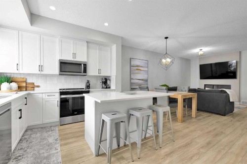 125 Emberside Hollow, Cochrane, AB - Indoor Photo Showing Kitchen With Upgraded Kitchen
