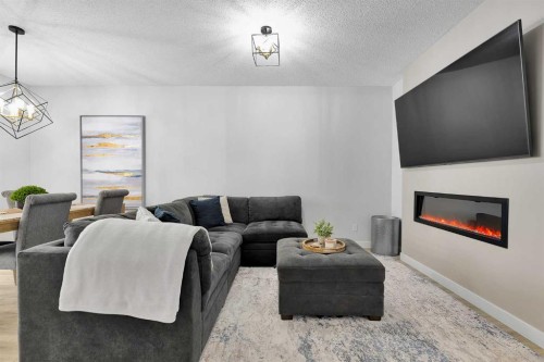 125 Emberside Hollow, Cochrane, AB - Indoor Photo Showing Living Room With Fireplace