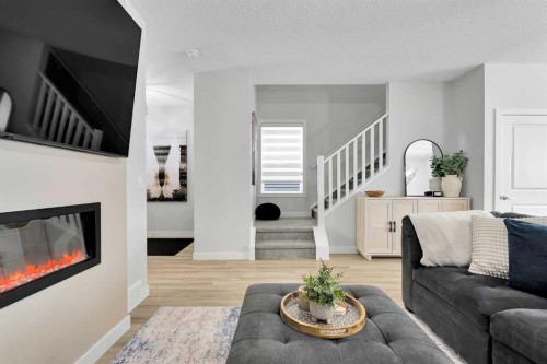 125 Emberside Hollow, Cochrane, AB - Indoor Photo Showing Living Room With Fireplace