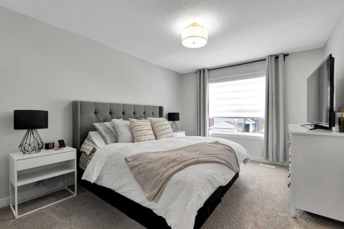 125 Emberside Hollow, Cochrane, AB - Indoor Photo Showing Bedroom