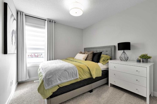 125 Emberside Hollow, Cochrane, AB - Indoor Photo Showing Bedroom