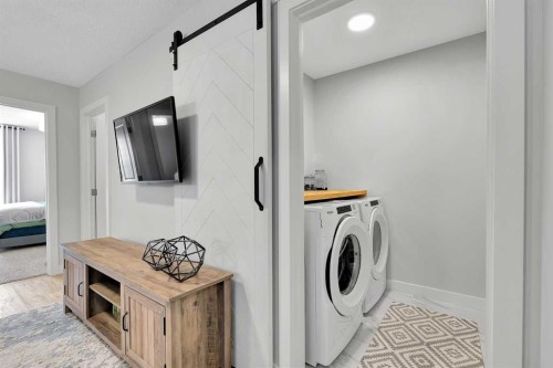 125 Emberside Hollow, Cochrane, AB - Indoor Photo Showing Laundry Room