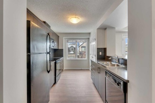 165 Windstone Avenue Sw, Airdrie, AB - Indoor Photo Showing Kitchen With Double Sink