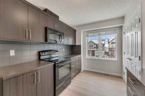 165 Windstone Avenue Sw, Airdrie, AB - Indoor Photo Showing Kitchen