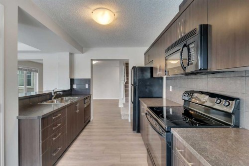 165 Windstone Avenue Sw, Airdrie, AB - Indoor Photo Showing Kitchen With Double Sink
