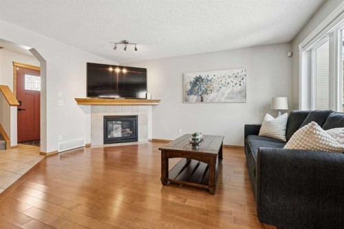 142 Cranfield Crescent Se, Calgary, AB - Indoor Photo Showing Living Room With Fireplace