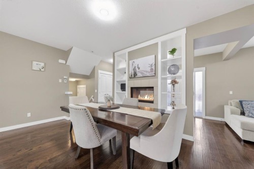 229 Rainbow Falls Glen, Chestermere, AB - Indoor Photo Showing Dining Room With Fireplace