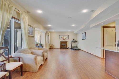 160 Tremblant Way Sw, Calgary, AB - Indoor Photo Showing Living Room With Fireplace