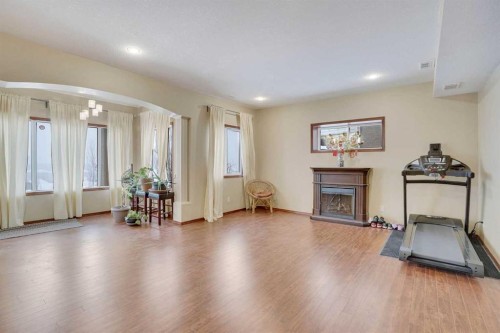 160 Tremblant Way Sw, Calgary, AB - Indoor Photo Showing Living Room With Fireplace