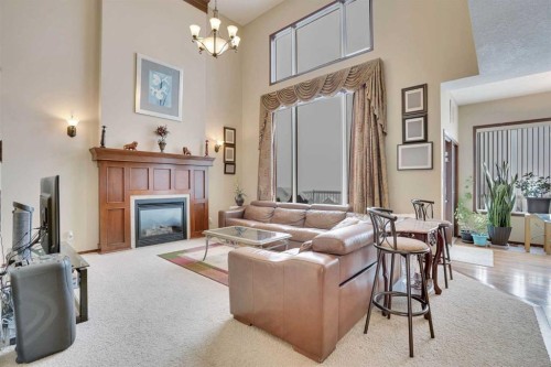 160 Tremblant Way Sw, Calgary, AB - Indoor Photo Showing Living Room With Fireplace