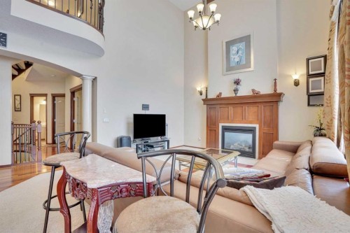 160 Tremblant Way Sw, Calgary, AB - Indoor Photo Showing Living Room With Fireplace