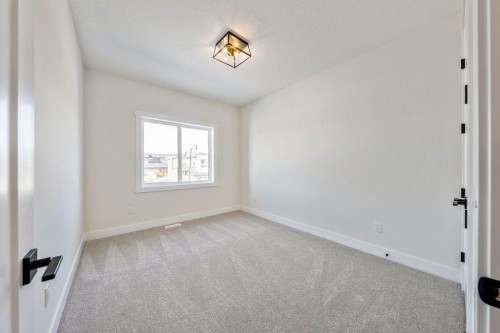 68 Sunvalley Way, Cochrane, AB - Indoor Photo Showing Other Room