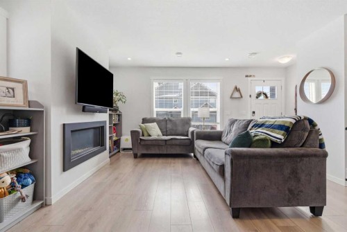 479 Cranbrook Square Se, Calgary, AB - Indoor Photo Showing Living Room With Fireplace