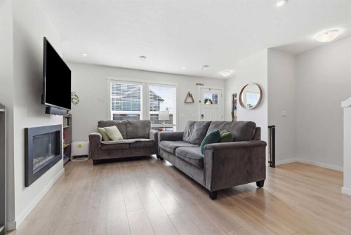 479 Cranbrook Square Se, Calgary, AB - Indoor Photo Showing Living Room With Fireplace