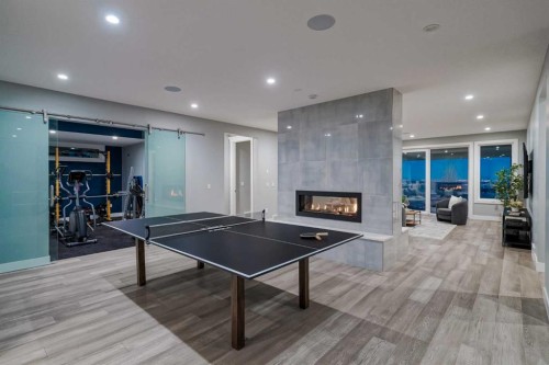 26 Patina Hill Sw, Calgary, AB - Indoor Photo Showing Other Room With Fireplace