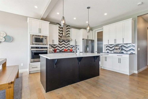 128 Sundown View, Cochrane, AB - Indoor Photo Showing Kitchen With Upgraded Kitchen
