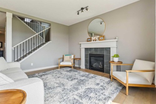 128 Sundown View, Cochrane, AB - Indoor Photo Showing Living Room With Fireplace