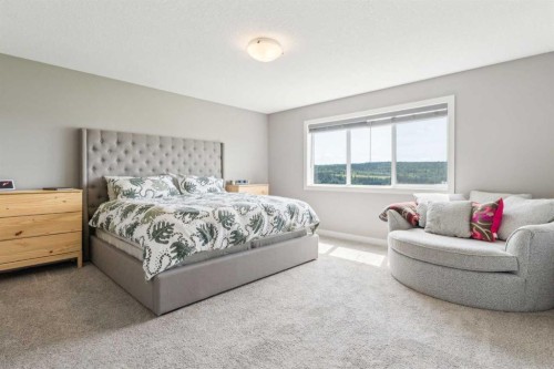 128 Sundown View, Cochrane, AB - Indoor Photo Showing Bedroom