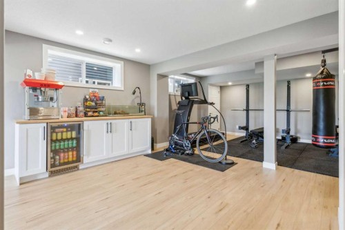 128 Sundown View, Cochrane, AB - Indoor Photo Showing Gym Room