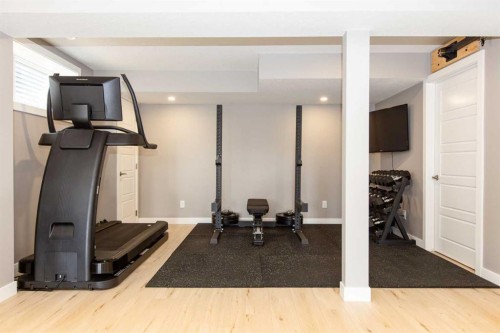 128 Sundown View, Cochrane, AB - Indoor Photo Showing Gym Room