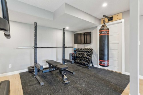 128 Sundown View, Cochrane, AB - Indoor Photo Showing Gym Room