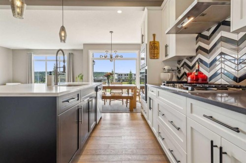 128 Sundown View, Cochrane, AB - Indoor Photo Showing Kitchen With Upgraded Kitchen