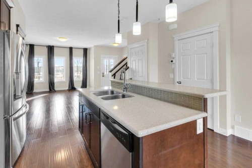 26 Willow Drive, Cochrane, AB - Indoor Photo Showing Kitchen With Double Sink