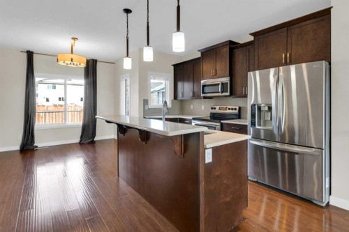 26 Willow Drive, Cochrane, AB - Indoor Photo Showing Kitchen With Upgraded Kitchen