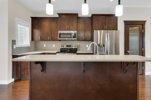 26 Willow Drive, Cochrane, AB - Indoor Photo Showing Kitchen With Upgraded Kitchen