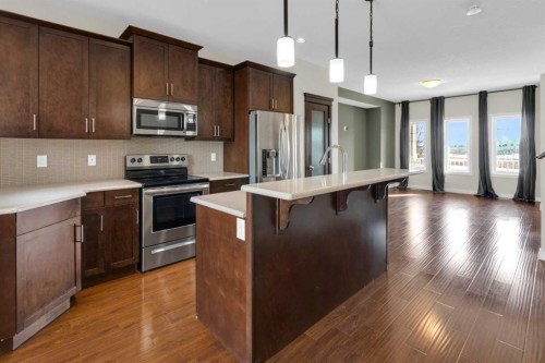 26 Willow Drive, Cochrane, AB - Indoor Photo Showing Kitchen With Upgraded Kitchen
